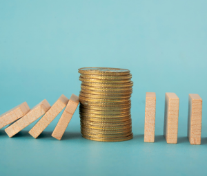 Stack of coins stops dominoes from falling